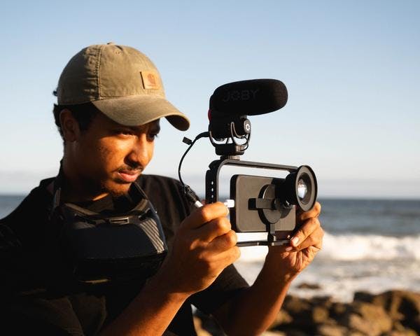 Man shooting a mobile rig with microphone on the beach