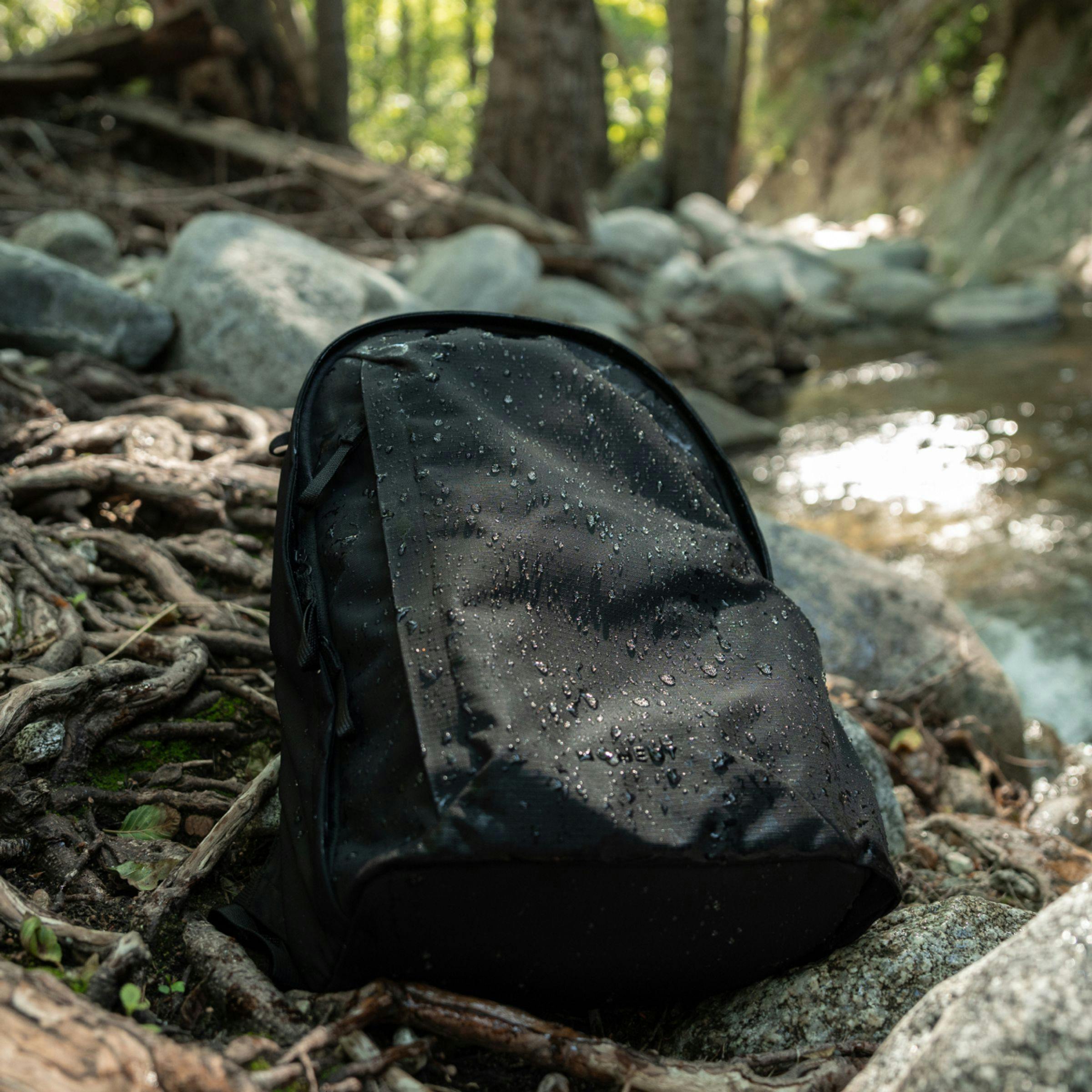 Everything Backpack in the wild under a light rainfall showing durability.
