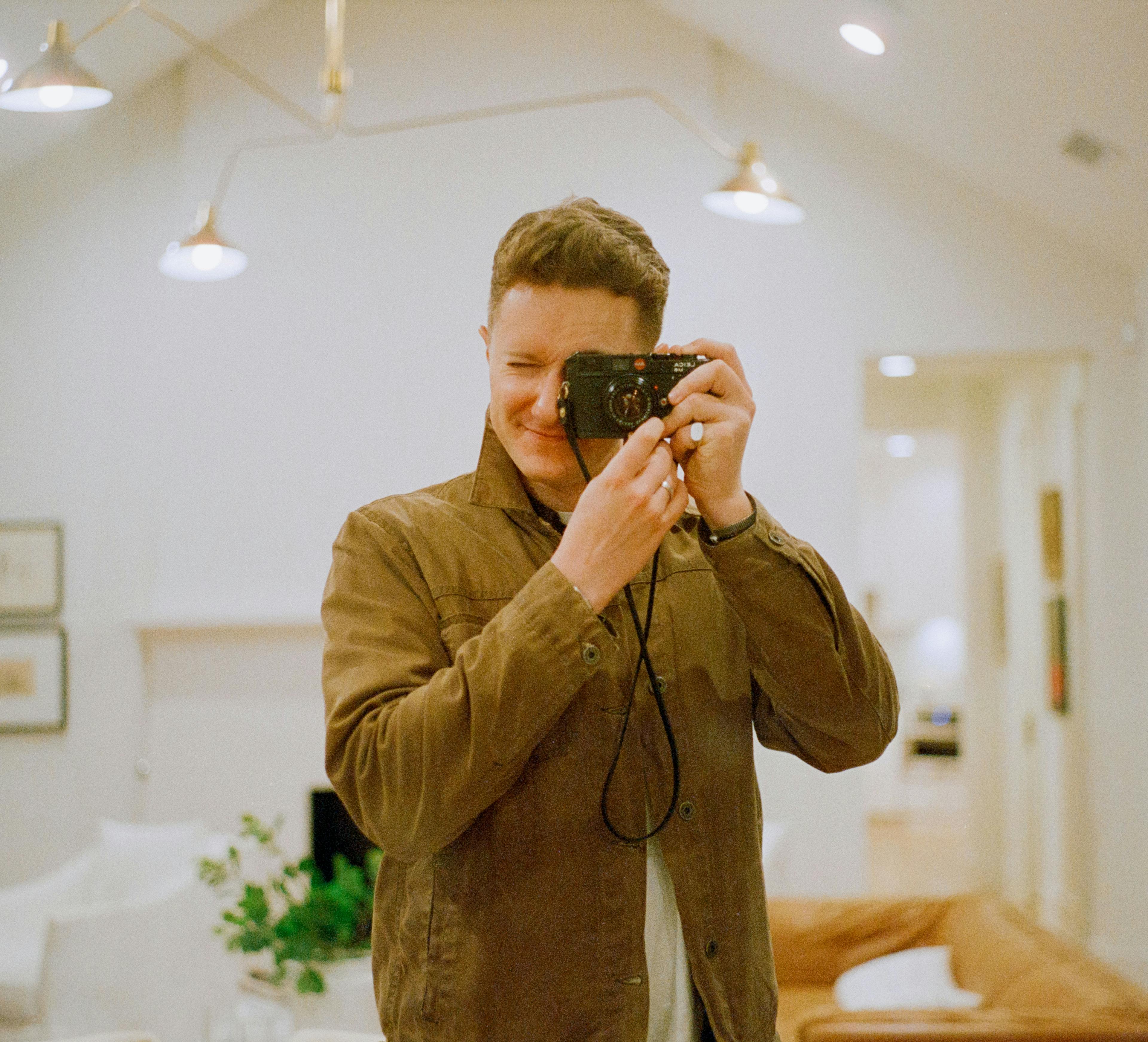 Self-portrait on my Leica film camera.